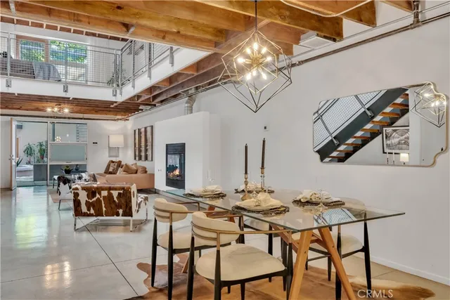 a kitchen with stainless steel appliances granite countertop a refrigerator a stove and a sink with wooden floor