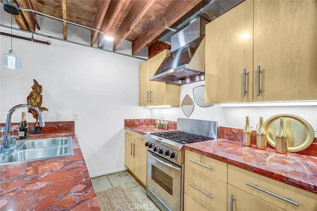 a kitchen with a sink and a wooden floor