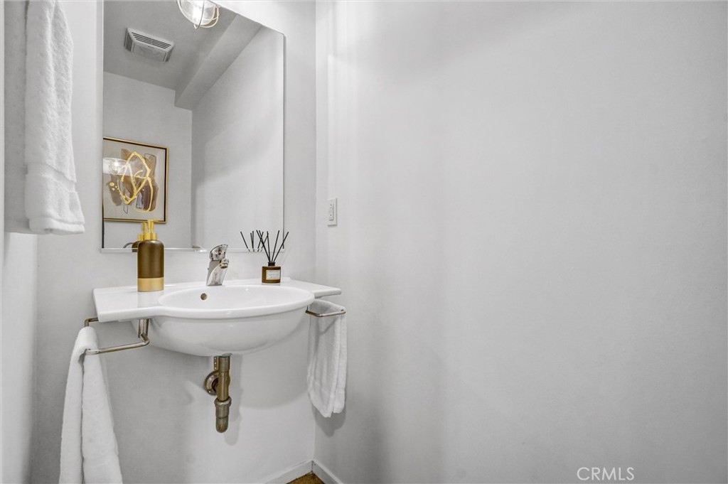849 Pine Avenue, Unit C Long Beach, CA 90813 - Photo 41 of 63 a bathroom with a sink mirror and toilet