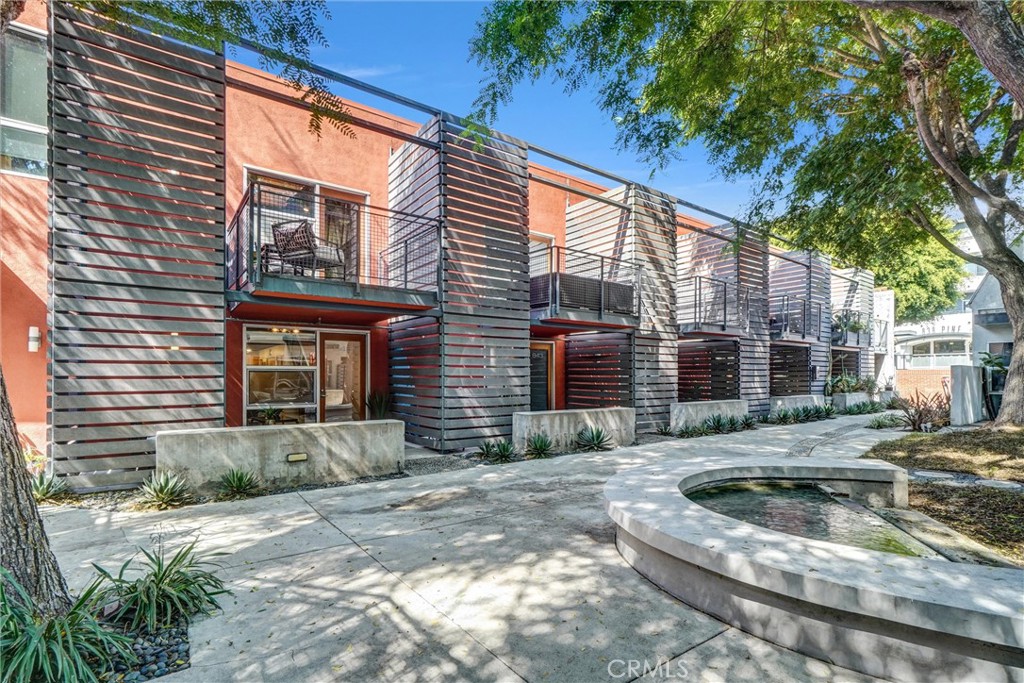849 Pine Avenue, Unit C Long Beach, CA 90813 - Photo 52 of 63 a view of a brick house with a yard plants and large tree