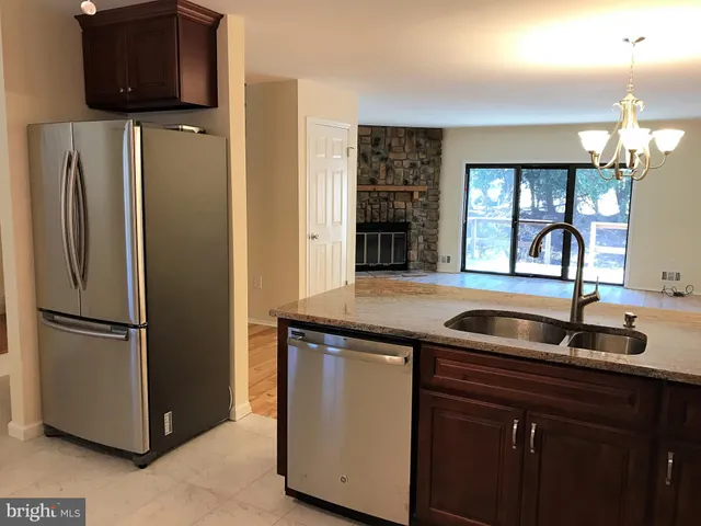 a kitchen with a refrigerator and a sink