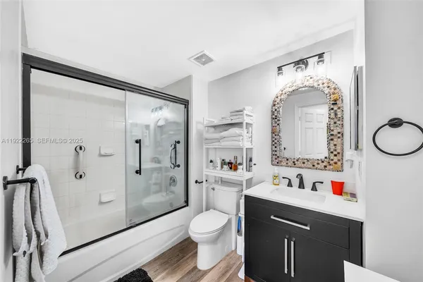 a bathroom with a sink vanity and mirror