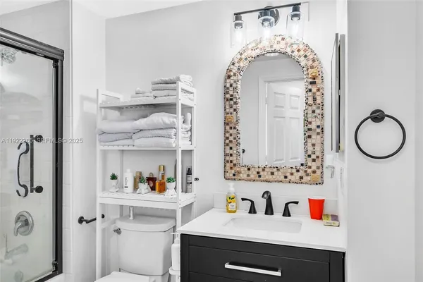 a bathroom with a shower and a sink