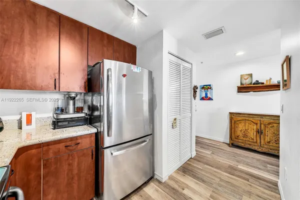 a kitchen with stainless steel appliances granite countertop a refrigerator sink and stove