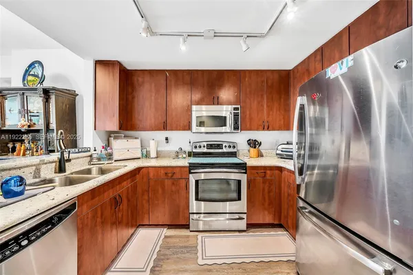 a kitchen with stainless steel appliances a stove a microwave and a refrigerator