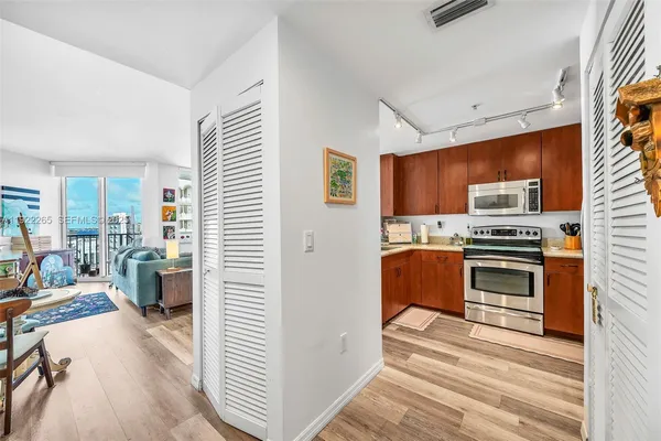 a kitchen with a sink stove and microwave