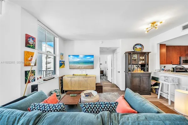a living room with furniture and a wooden floor