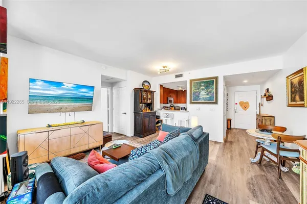 a living room with furniture and a wooden floor