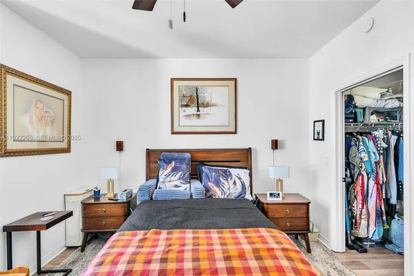 a bedroom with a bed bookshelf and a window