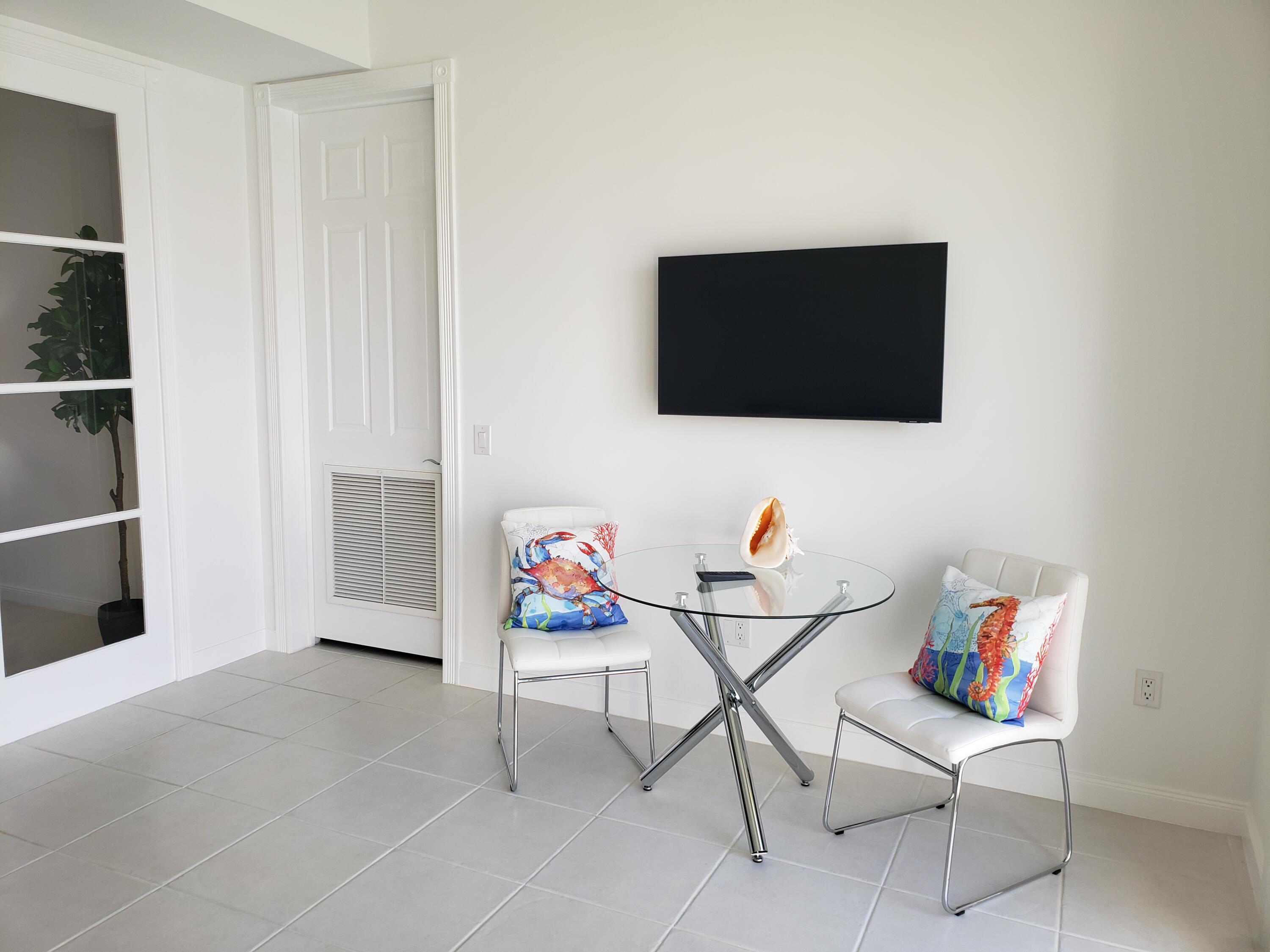 10 Harbour Isle Drive East, Unit 204 Fort Pierce, FL 34949 - Photo 12 of 20 a living room with furniture and a flat screen tv