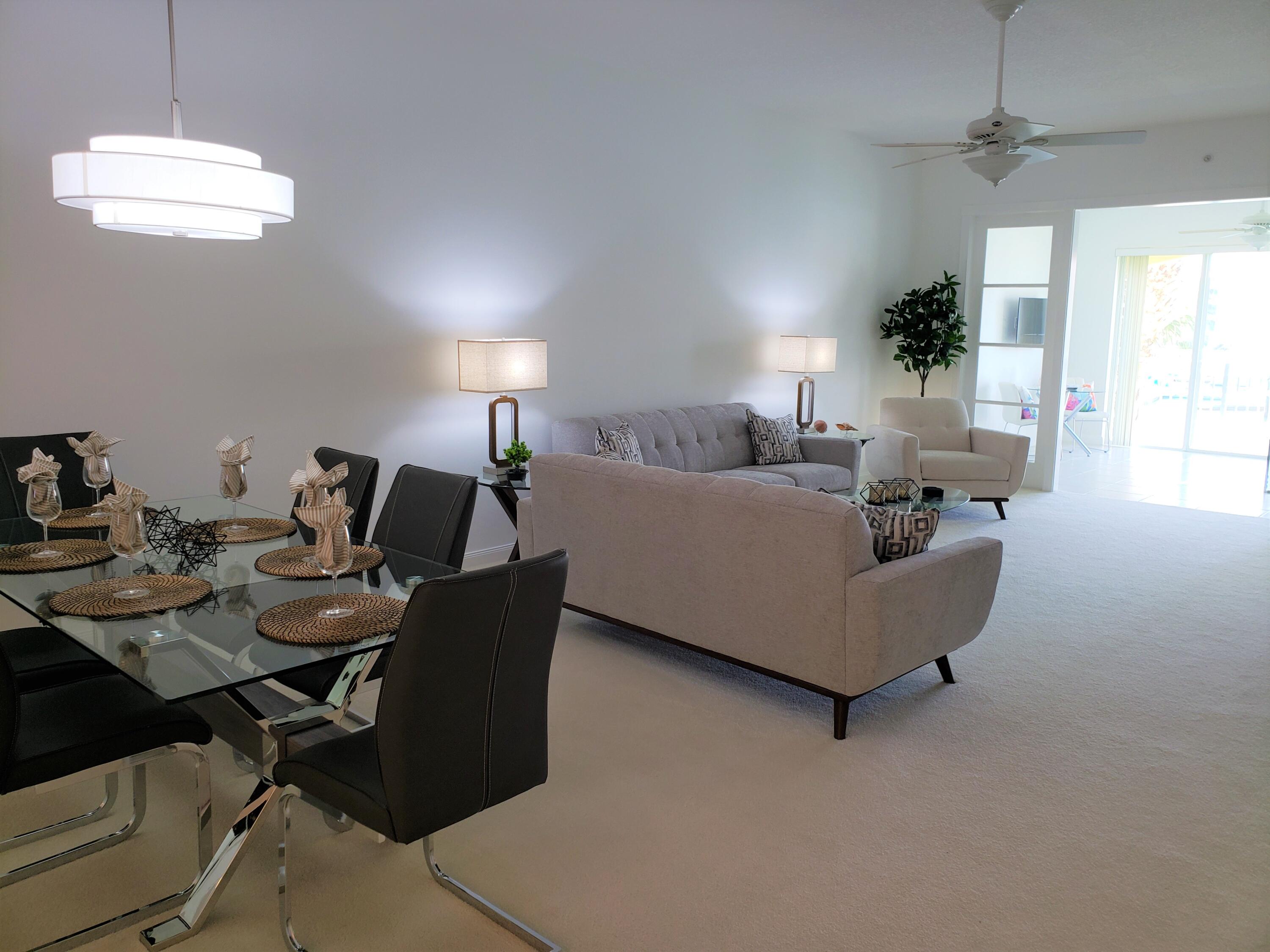 10 Harbour Isle Drive East, Unit 204 Fort Pierce, FL 34949 - Photo 5 of 20 a living room with furniture and a chandelier