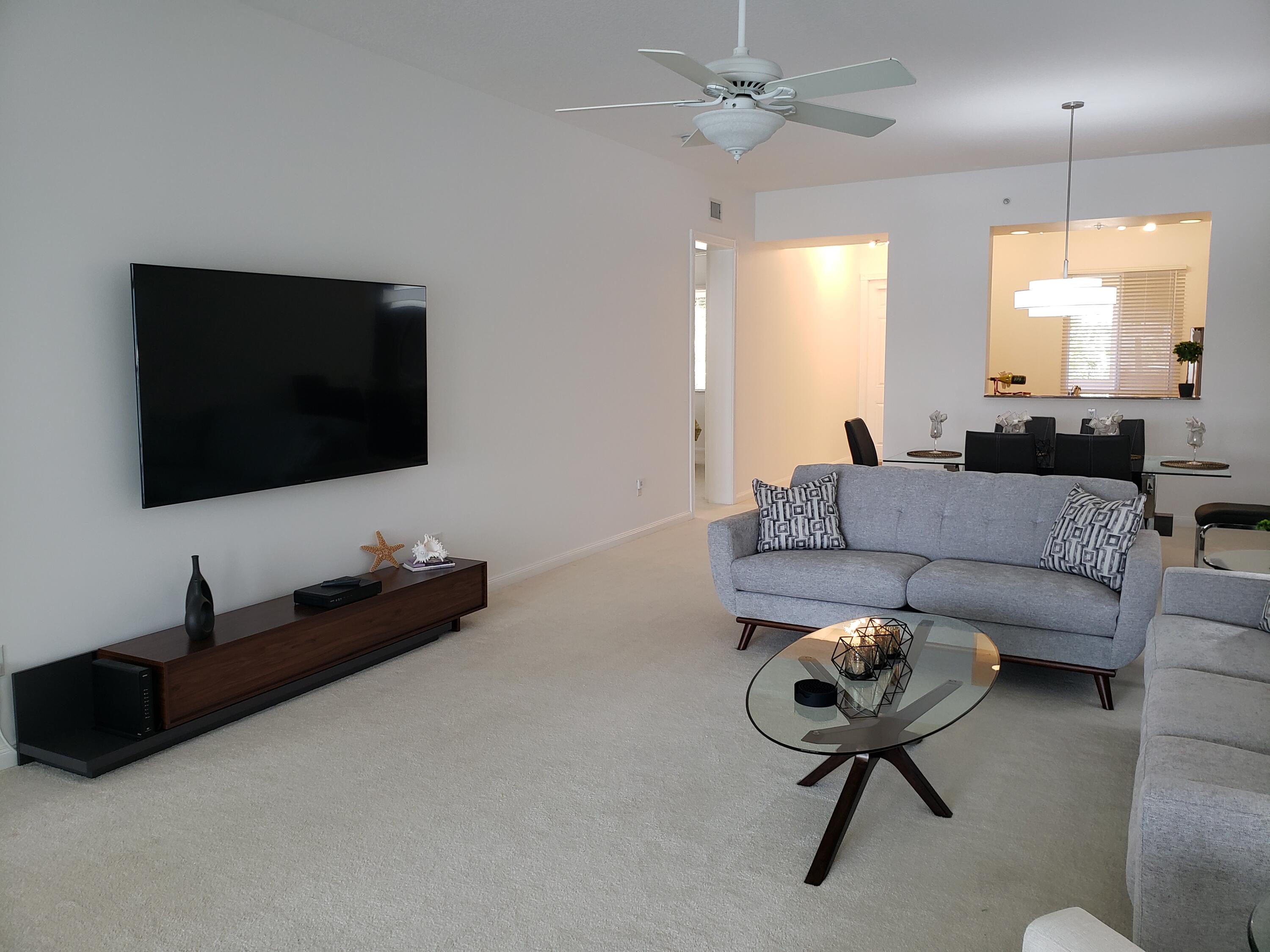 10 Harbour Isle Drive East, Unit 204 Fort Pierce, FL 34949 - Photo 7 of 20 a living room with furniture and a flat screen tv