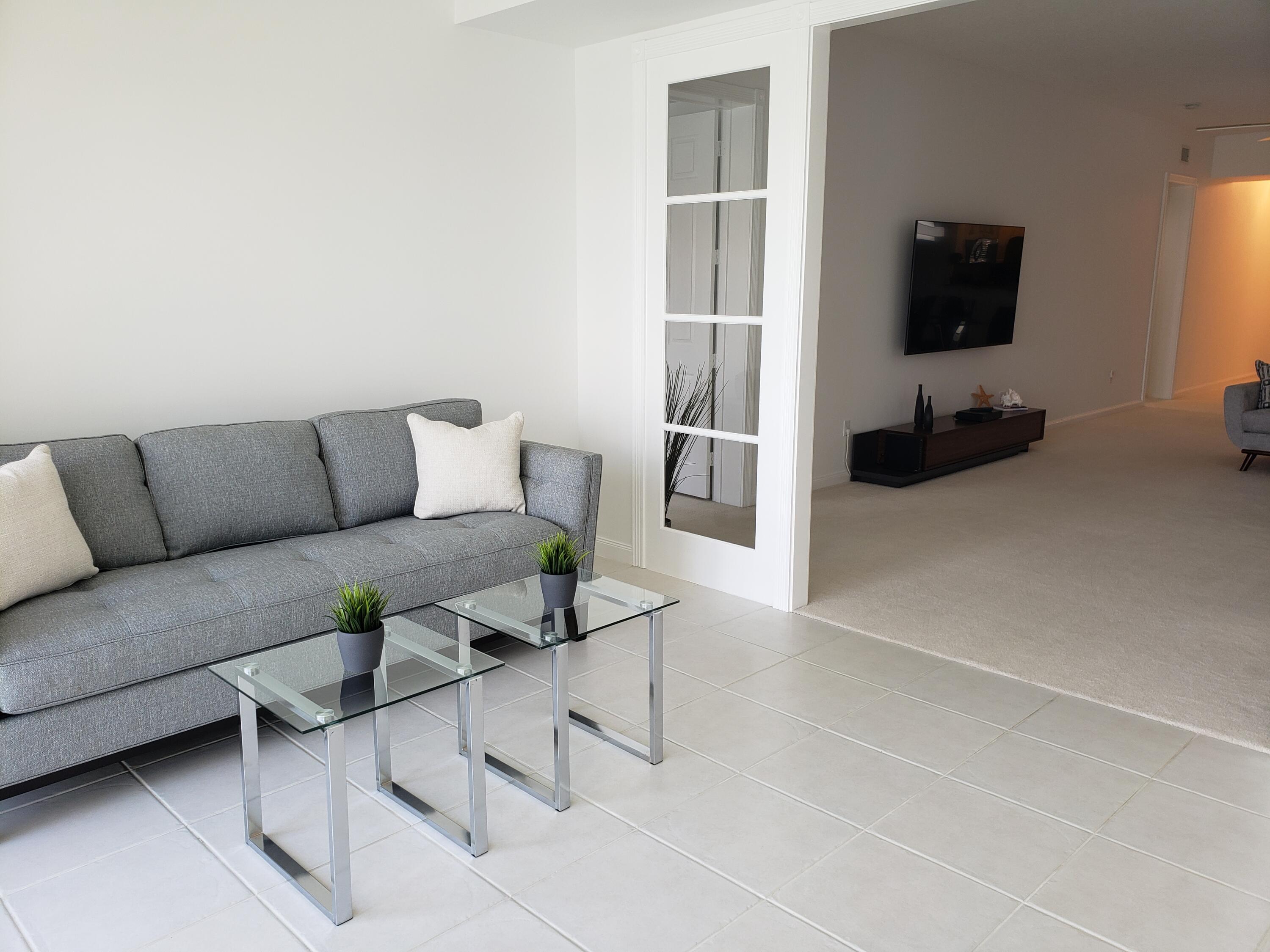 10 Harbour Isle Drive East, Unit 204 Fort Pierce, FL 34949 - Photo 9 of 20 a living room with furniture and a flat screen tv