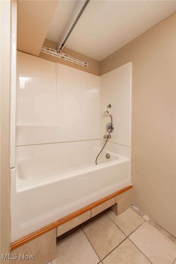 27680 Dunford Road Westlake, OH 44145 - Photo 14 of 31 Bathroom featuring tile patterned floors and a bathtub