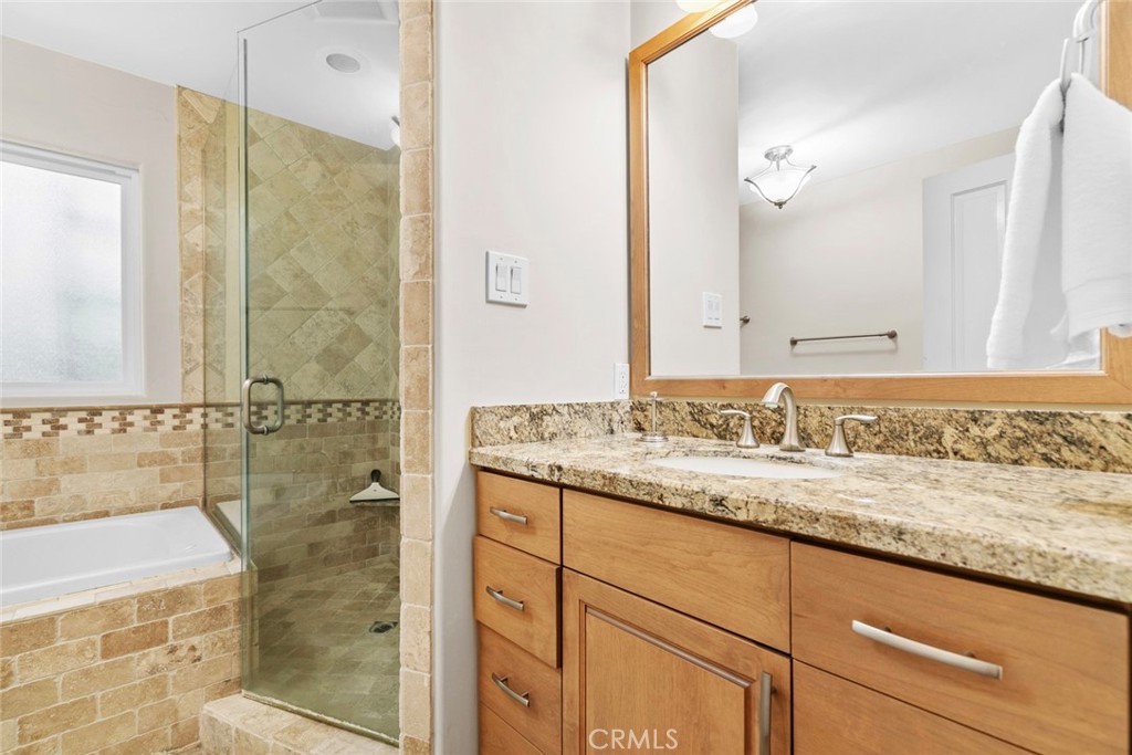 545 Spencer Street Glendale, CA 91202 - Photo 13 of 21 a bathroom with a granite countertop sink a mirror and shower