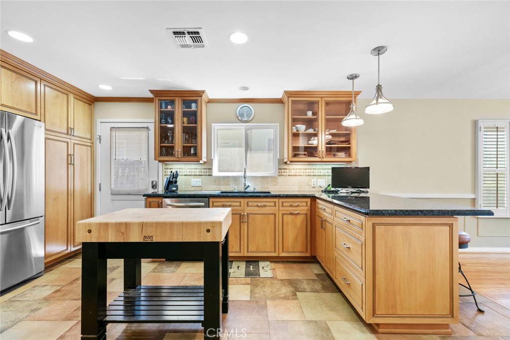 545 Spencer Street Glendale, CA 91202 - Photo 8 of 21 a kitchen with stainless steel appliances granite countertop a sink stove and refrigerator