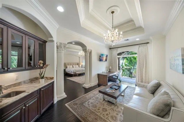 a living room with furniture and a chandelier