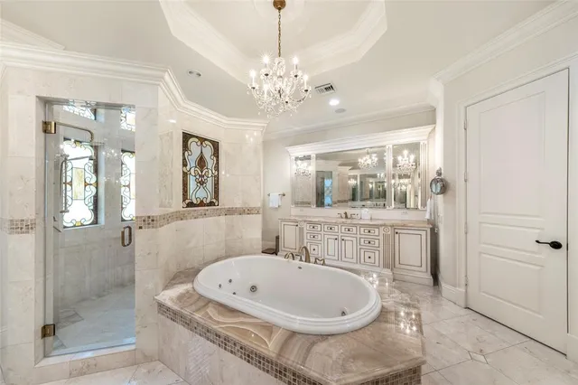 a bathroom with a tub a sink shower and mirror
