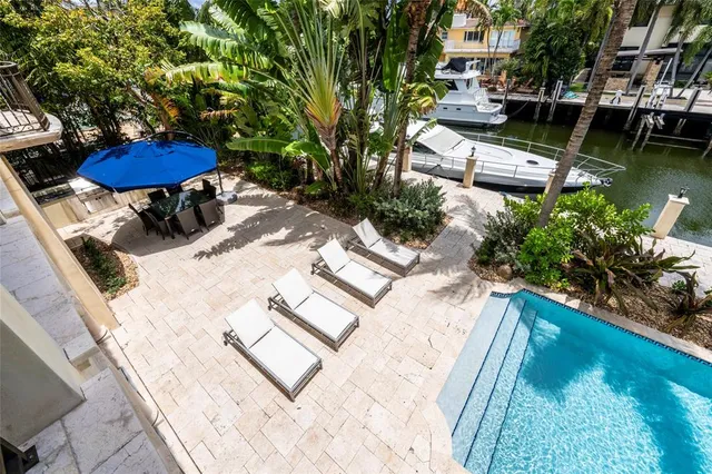 a view of a patio with table and chairs under an umbrella