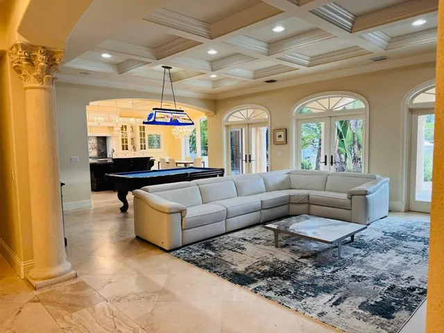a living room with furniture and a chandelier