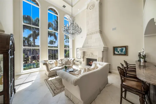 a living room with furniture a fireplace and a large window