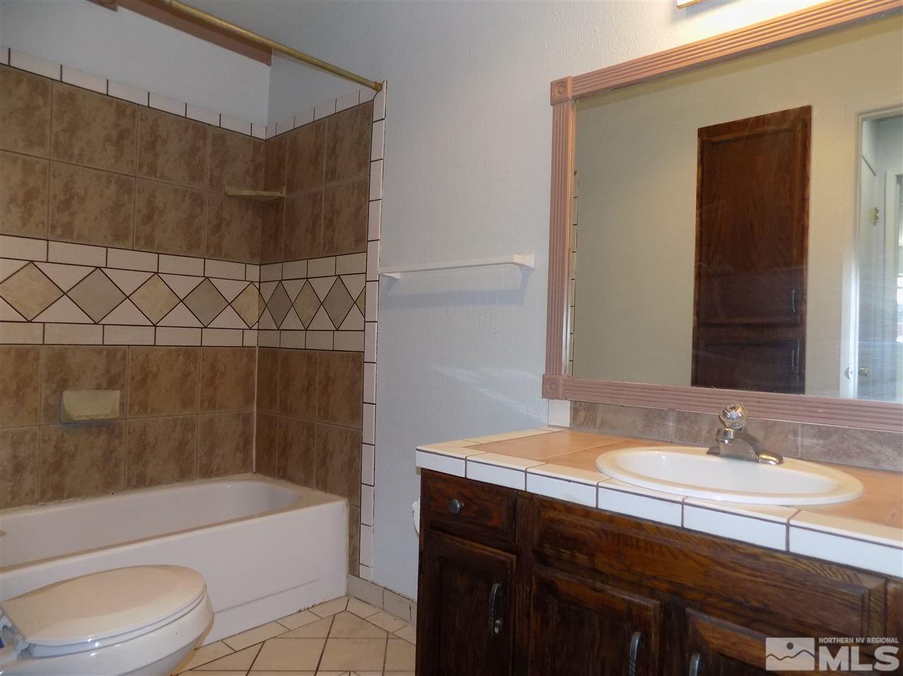 2189 Kietzke Lane Reno, NV 89502 - Photo 16 of 20 a bathroom with a sink a toilet and bathtub