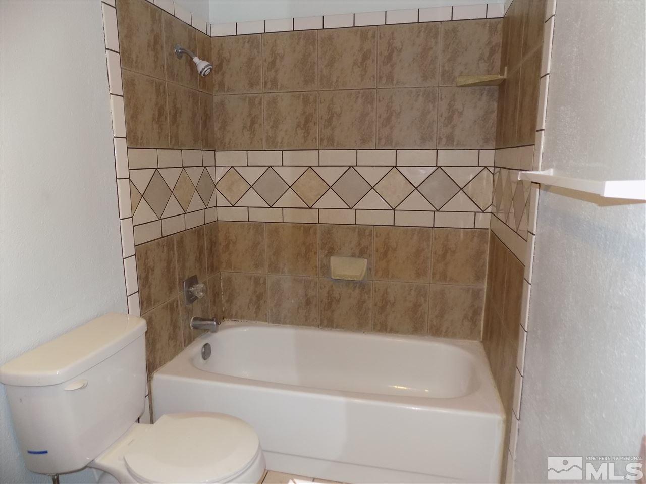 2189 Kietzke Lane Reno, NV 89502 - Photo 17 of 20 a bathroom with a bathtub and a toilet