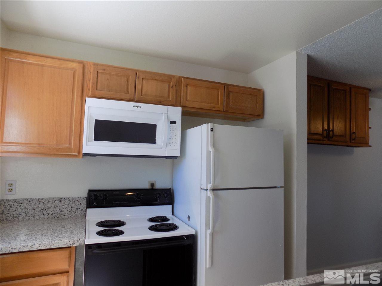 2189 Kietzke Lane Reno, NV 89502 - Photo 7 of 20 a kitchen with a refrigerator and a stove top oven