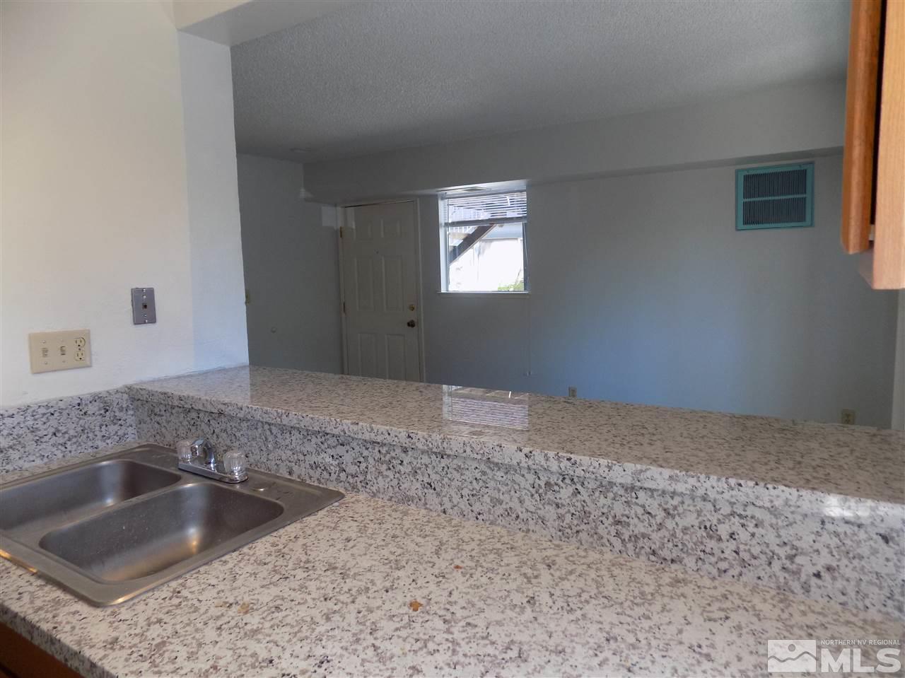 2189 Kietzke Lane Reno, NV 89502 - Photo 9 of 20 a kitchen with a sink granite counter tops and a window