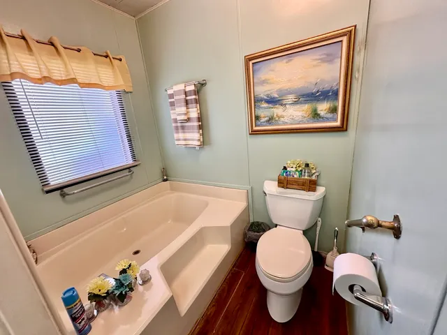 a bathroom with a toilet a sink and tub