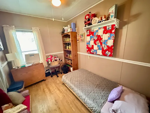 a bedroom with furniture and a book shelf