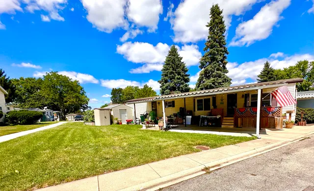 a view of a house with a backyard porch and sitting area