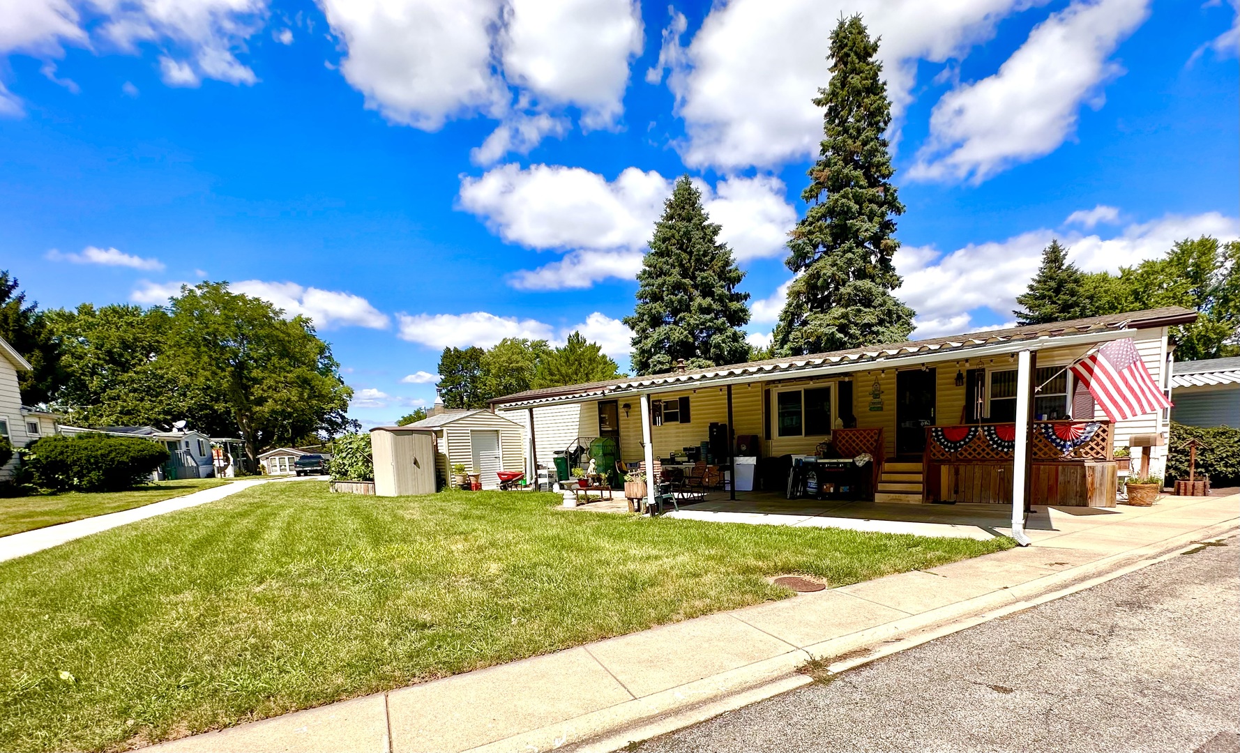 1336 Douglas Avenue, Unit 13 Montgomery, IL 60538 - Photo 17 of 23 a view of a house with a backyard porch and sitting area