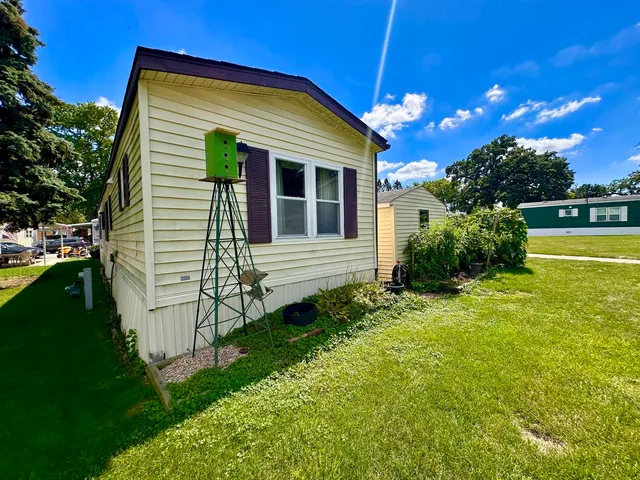 a view of a house with backyard and sitting area