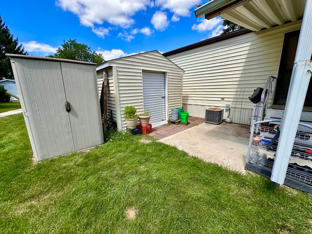 a backyard of a house with table and chairs