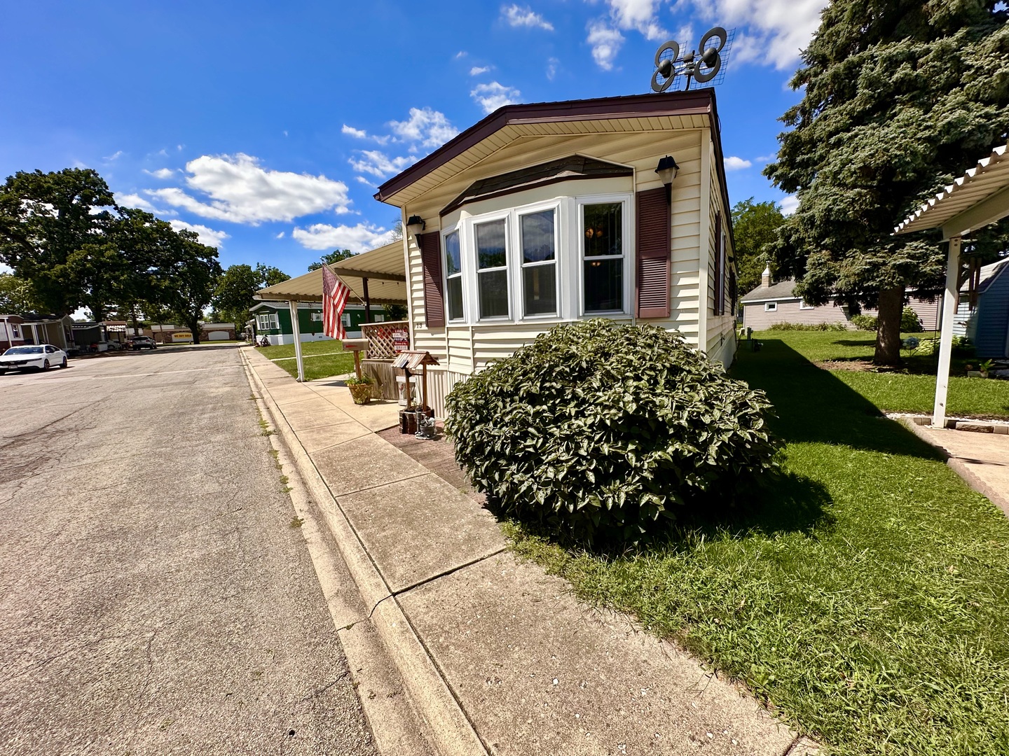 1336 Douglas Avenue, Unit 13 Montgomery, IL 60538 - Photo 2 of 23 a front view of a house with a yard