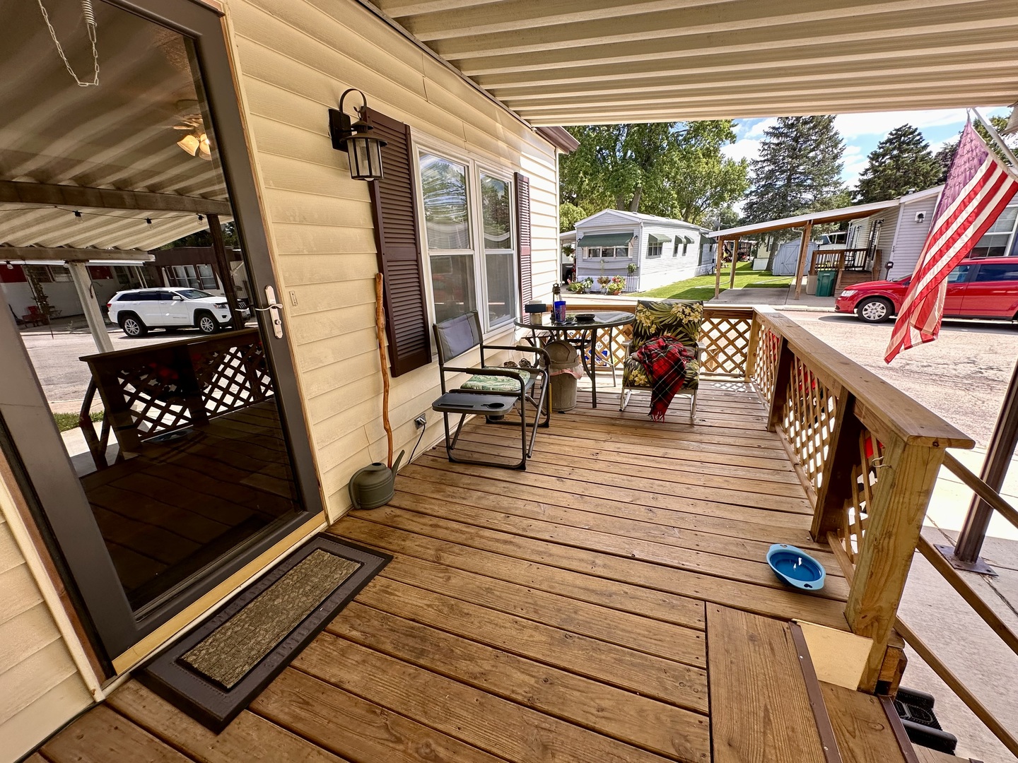 1336 Douglas Avenue, Unit 13 Montgomery, IL 60538 - Photo 22 of 23 a view of a balcony with chairs and wooden floor