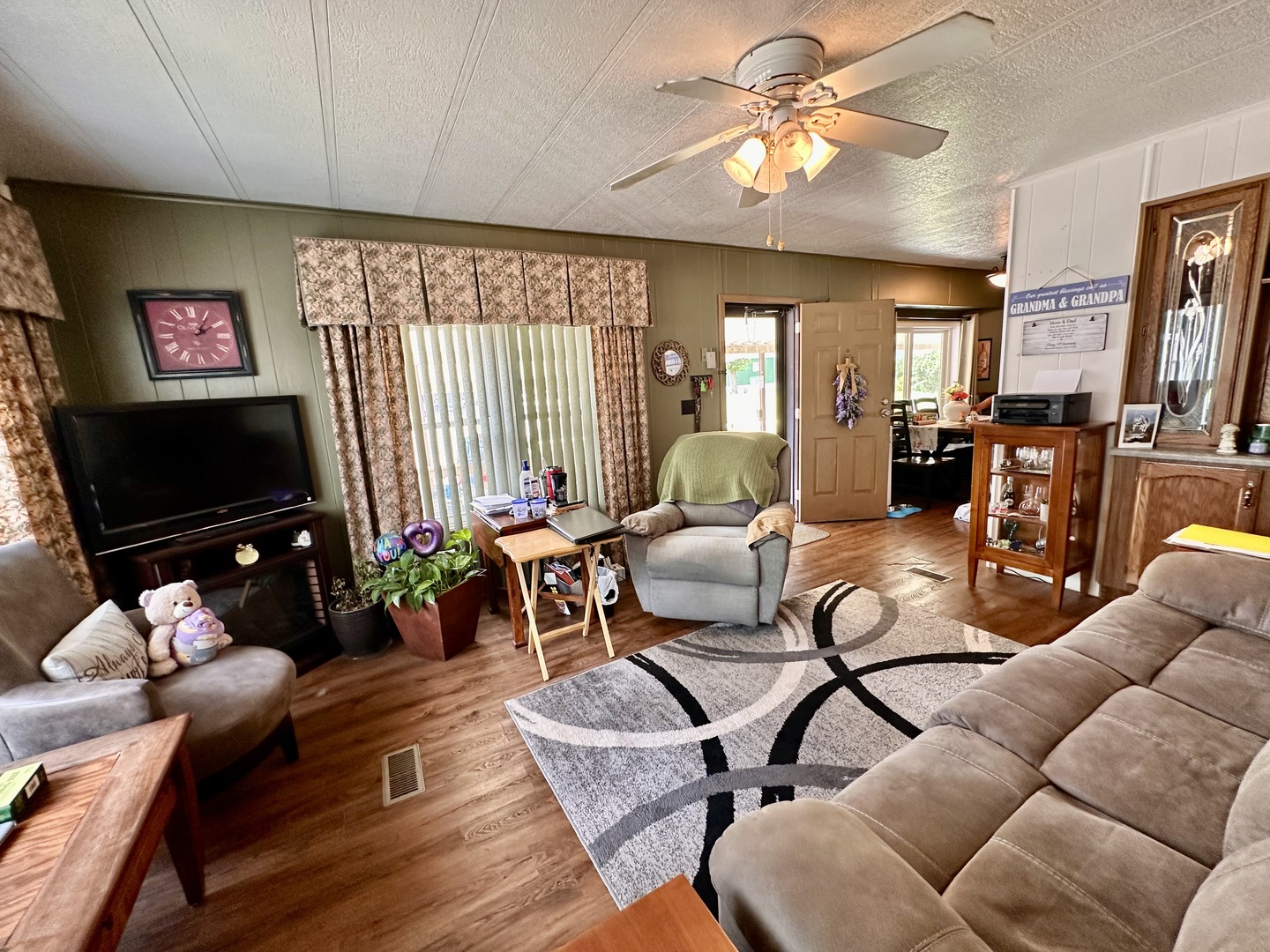 1336 Douglas Avenue, Unit 13 Montgomery, IL 60538 - Photo 6 of 23 a living room with furniture a flat screen tv and wooden floor