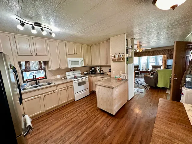 a kitchen with cabinets wooden floor and a counter top space