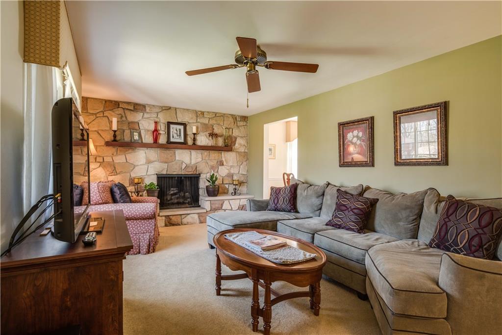 842 Rosalind Road Pittsburgh, PA 15237 - Photo 2 of 21 THIS LIVING ROOM IS 20' X 11'5", BOASTS HARDWOOD FLOORING BENEATH THE CARPETING AND FEATURES A BEAUTIFUL STONE GAS FIREPLACE. THE CUSTOM CORNICE WINDOW TREATMENTS CAN STAY WITH THE HOME.