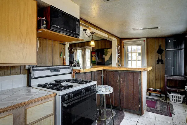 a kitchen with a stove and a refrigerator