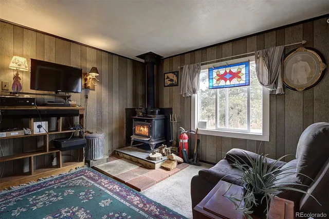 a living room with furniture a flat screen tv and a window
