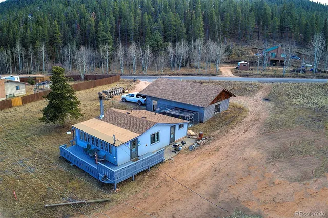 a view of a backyard with plants and a patio