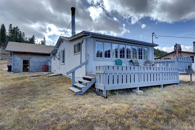 a view of a house with a wooden deck