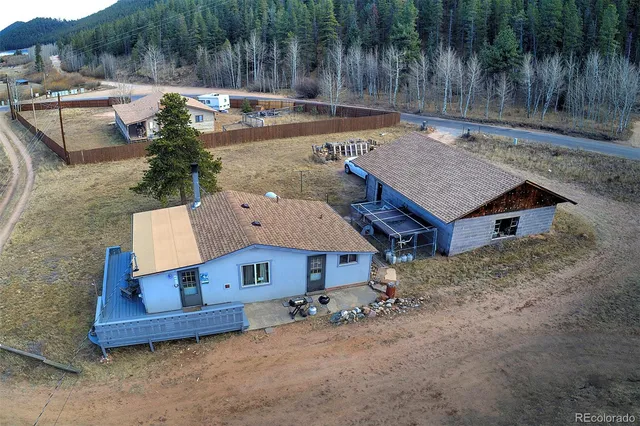 an aerial view of a house with garden space and sitting area