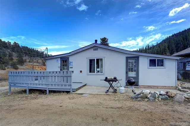 a view of a house with a wooden fence