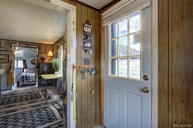 a view of a hallway with wooden floor and windows