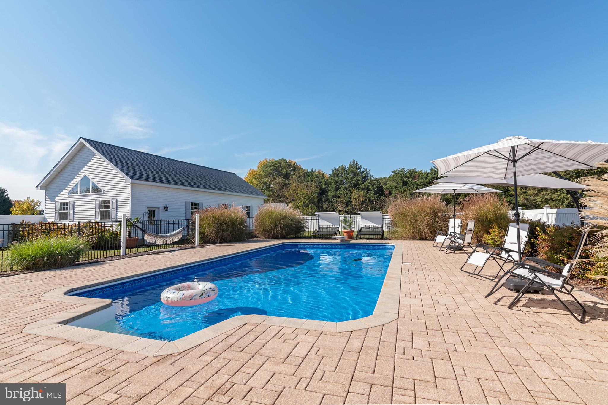 6660 Reeses Pride Road Sherwood, MD 21665 - Photo 18 of 72 a view of a swimming pool with lounge chairs