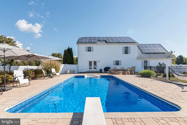 a table and chairs in front of a house