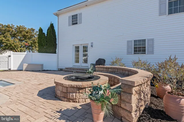 a kitchen with stainless steel appliances granite countertop a stove a sink a refrigerator and a microwave